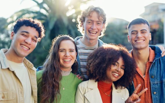 five-smiling-young-adults-gathered-outside-on-sunn-2026-01-09-11-37-28-utc (1)